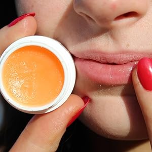 smooth hydrating lindi skin lip balm being applied to chapped lips